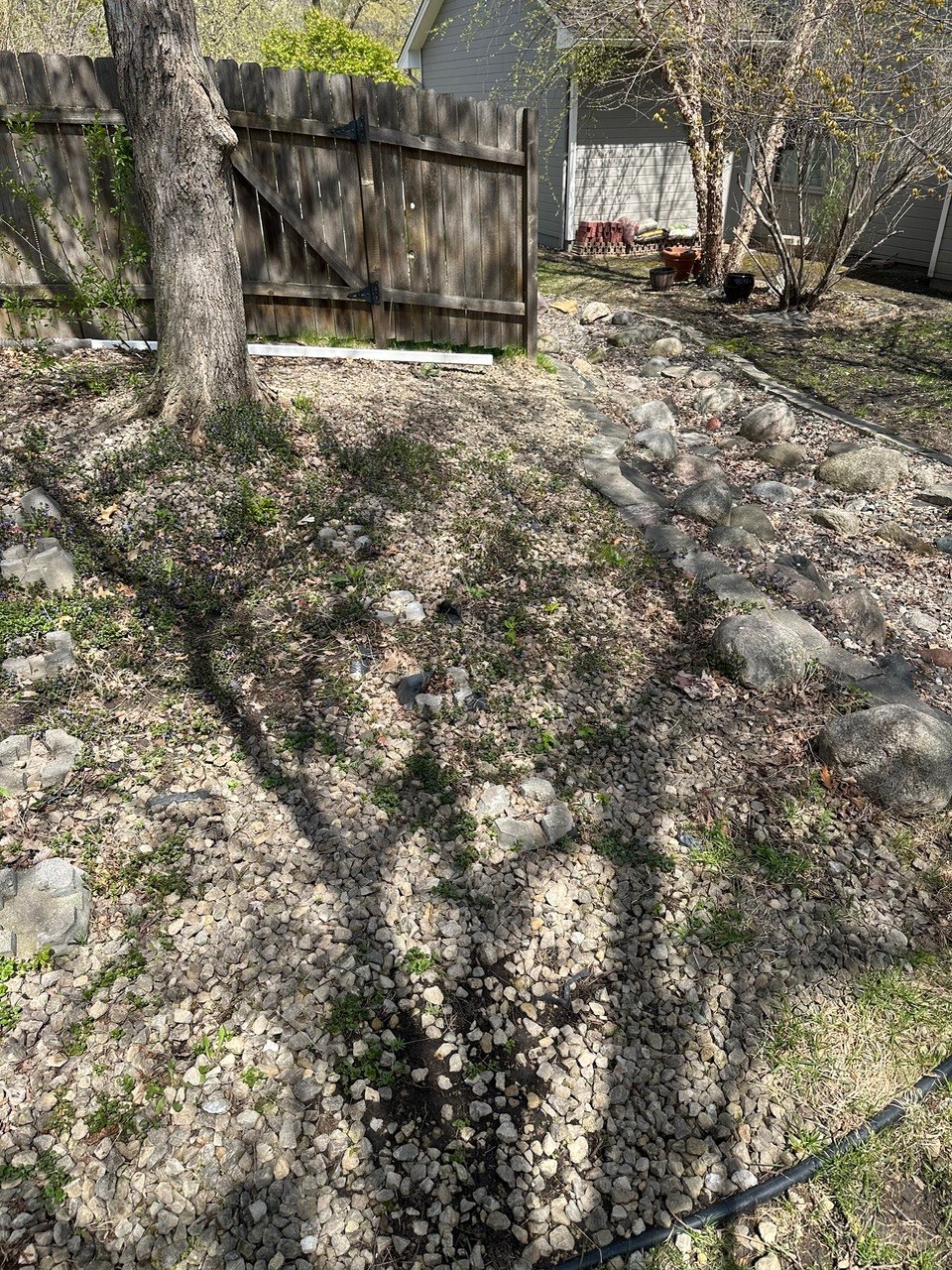 Fence line gravel cleanup before